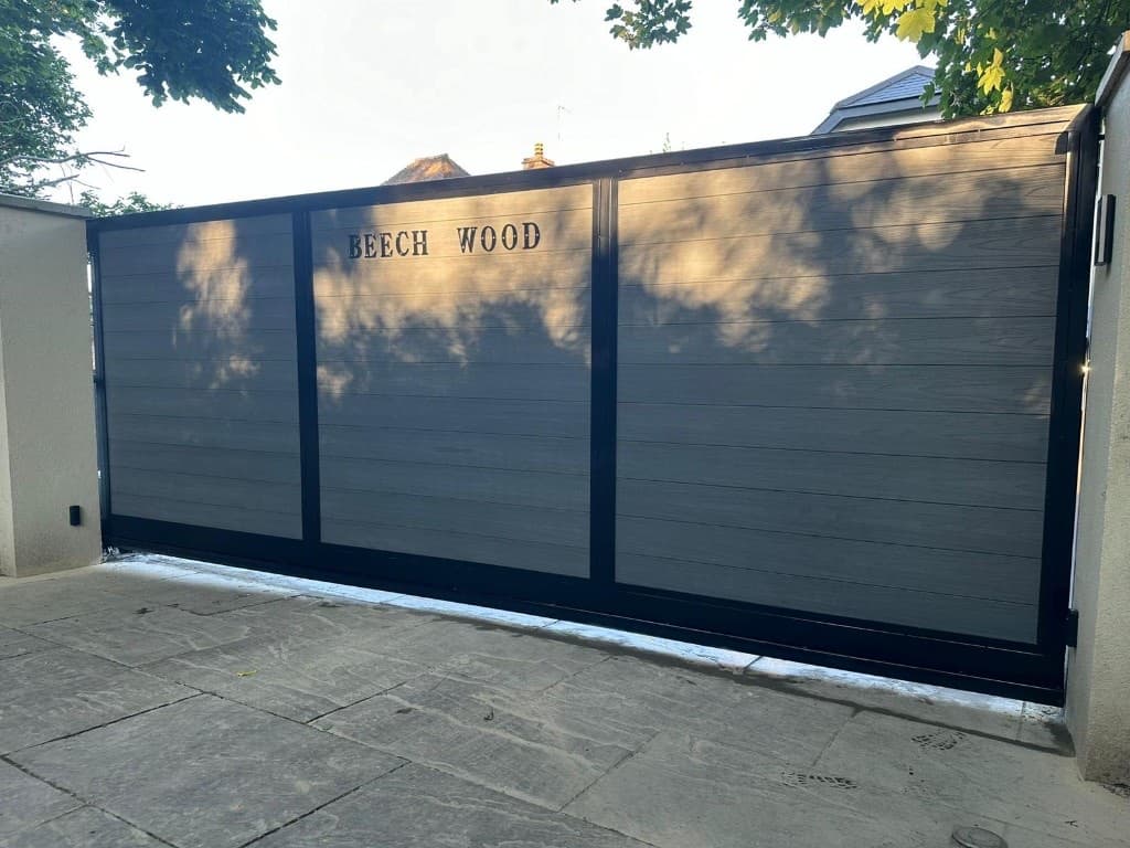 Privacy sliding gate with horizontal composite infill panels in a black steel frame